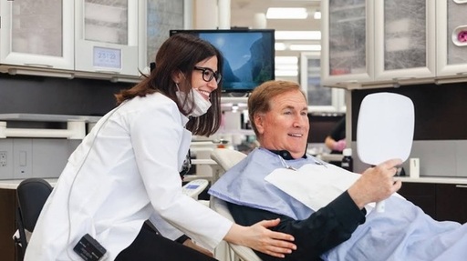Dentist and patient reviewing smile results during